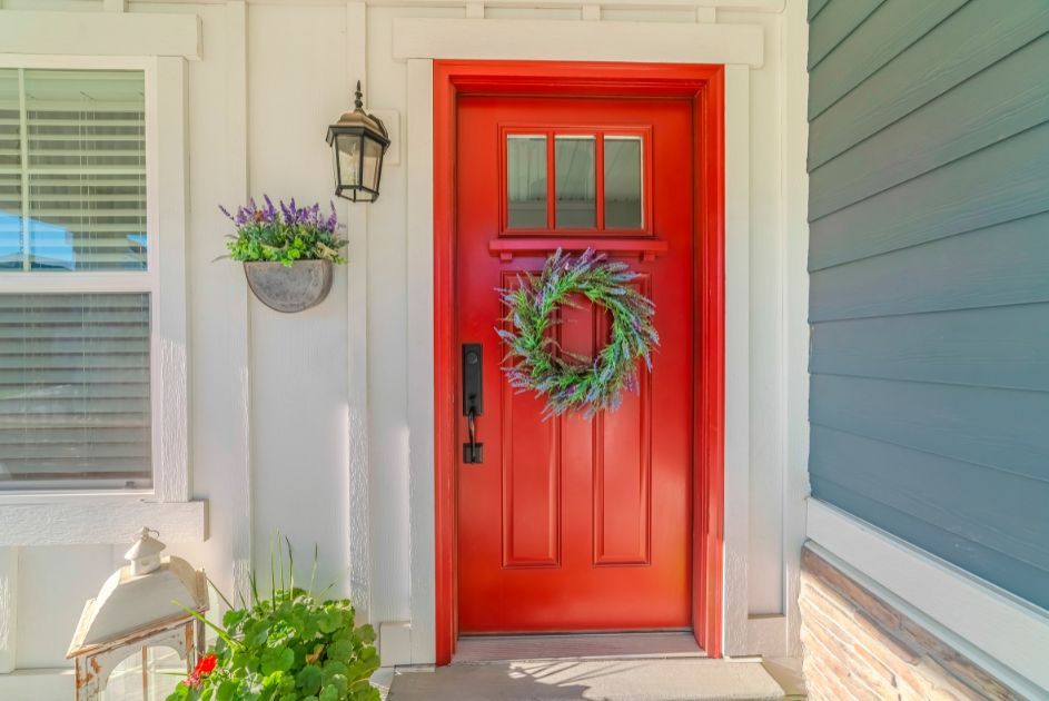 red front door of home with lavender wreath