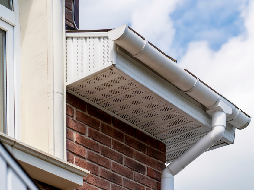 A roof eave with soffit ventilation vents on the underside.