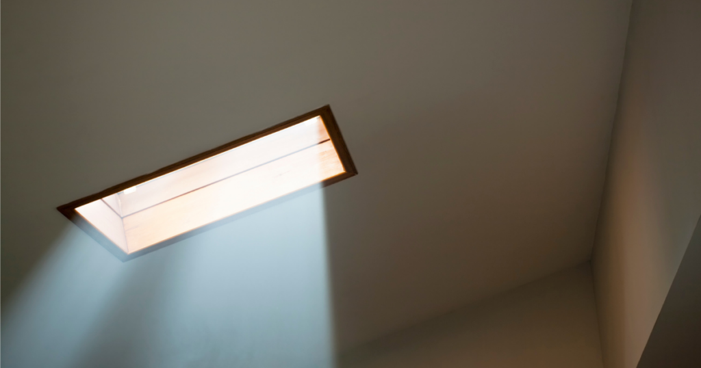 A skylight from the inside, puring sunlight into the room.