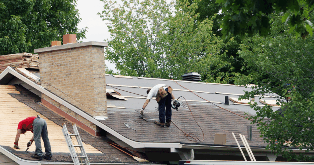 people working on installing a roof