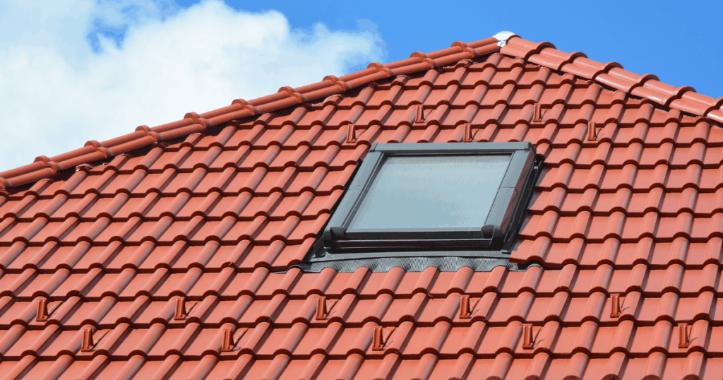 skylight on red shingle roof