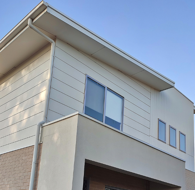 beige home with siding
