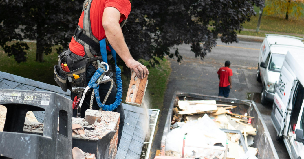 person tossing away roof debris