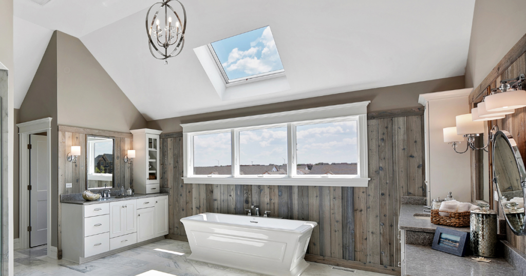 view of bathroom with large windows and a skylight