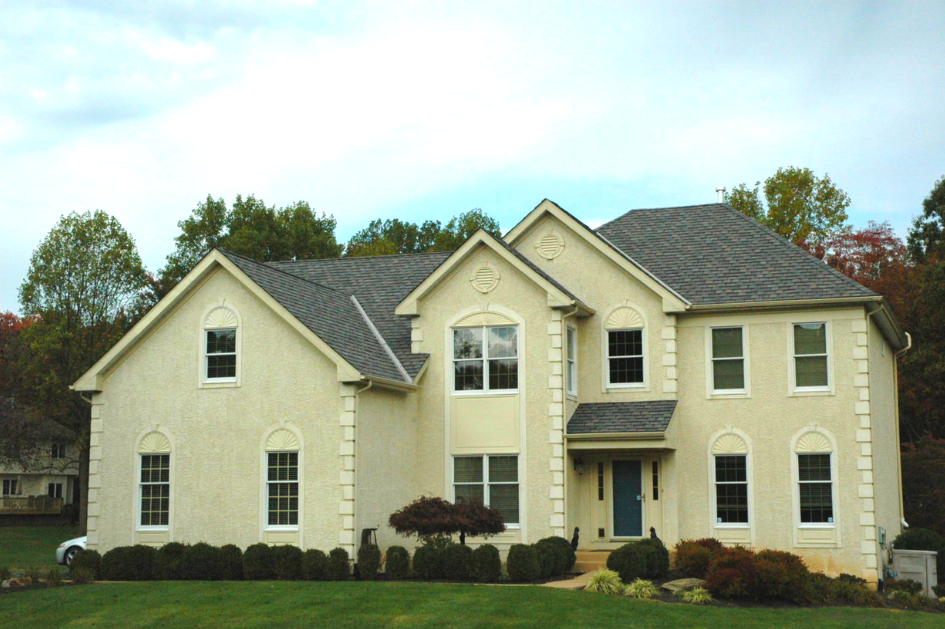 Beige home with driftwood shingle roof