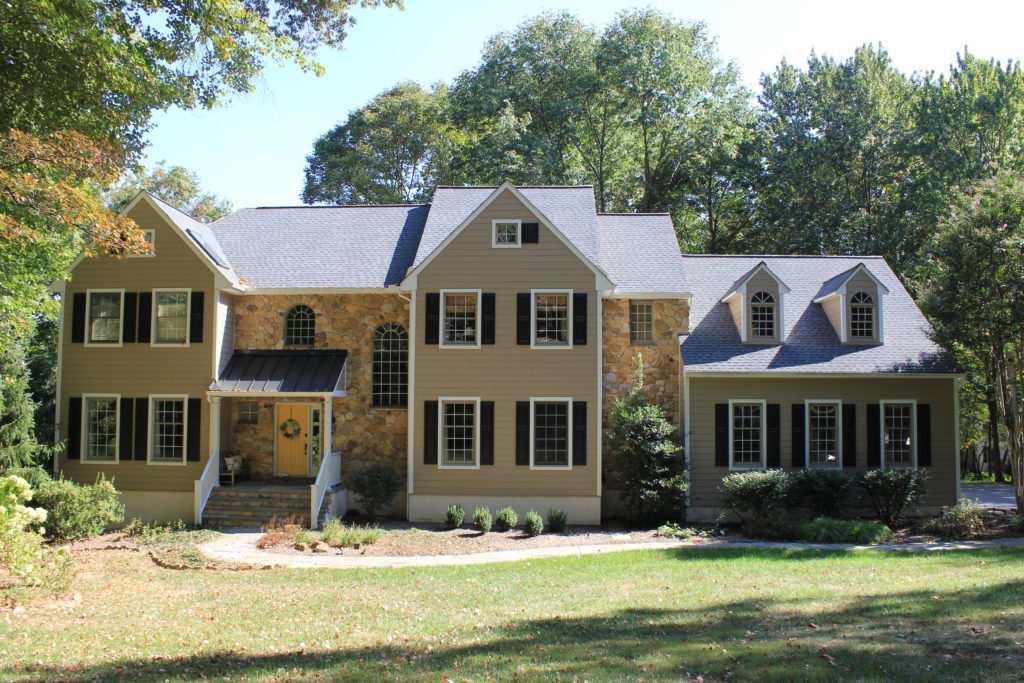 Picture of a tan and stone house