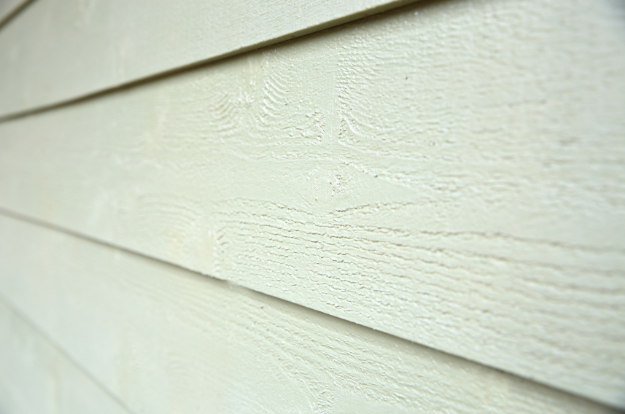 A super close up shot of fiber cement siding on a house