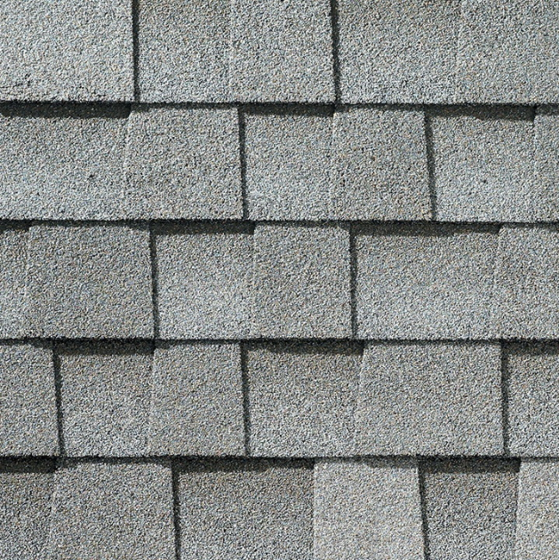 close up image of GAF architectural shingles in a light grey color.