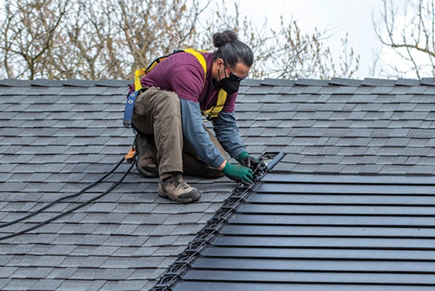 man installing asphalt shingle roof