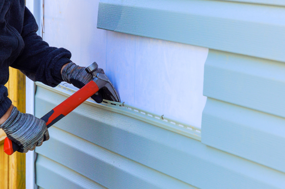 man removing siding panels from home
