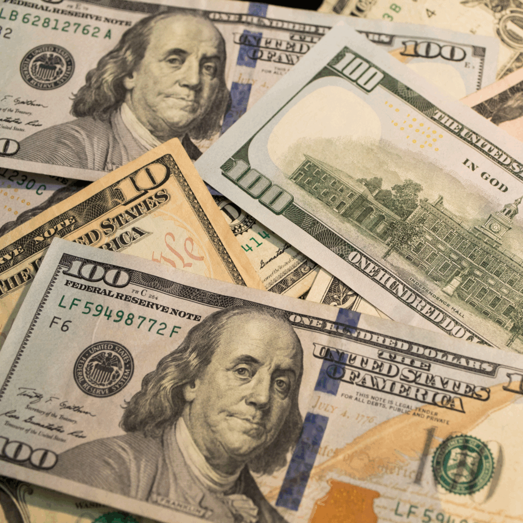 Pile of $100 and $10 bills