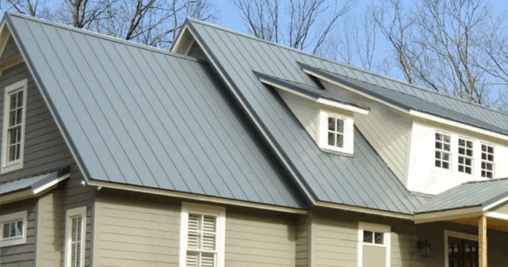 House with a sleek, grey standing seam metal roof.